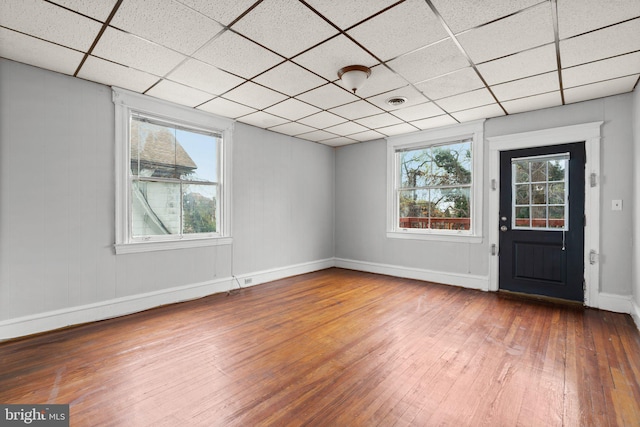 entryway featuring wood-type flooring and a drop ceiling