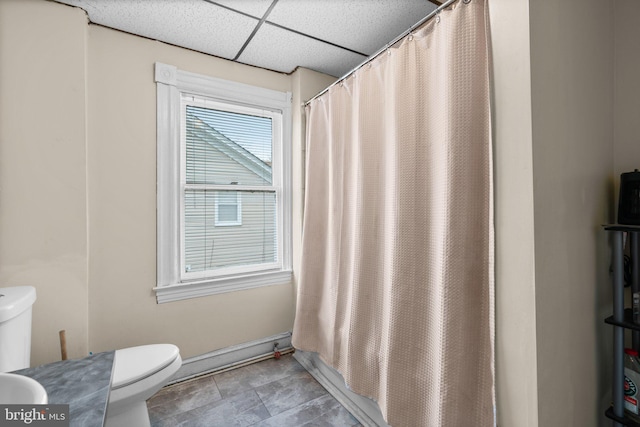 full bathroom featuring a paneled ceiling, vanity, shower / bath combination with curtain, and toilet