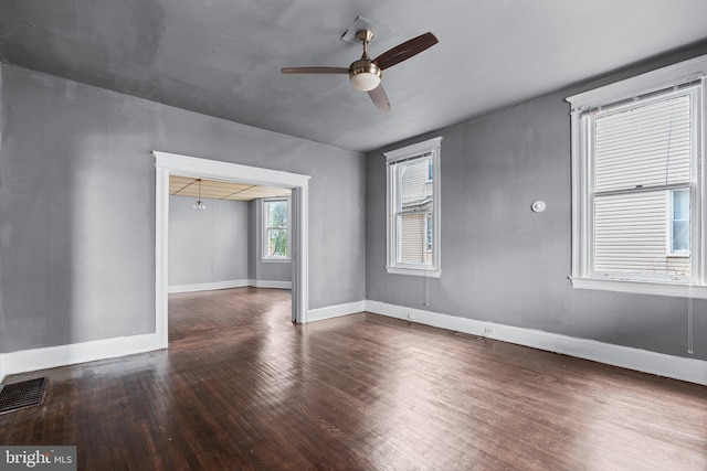 unfurnished room with ceiling fan and dark hardwood / wood-style flooring