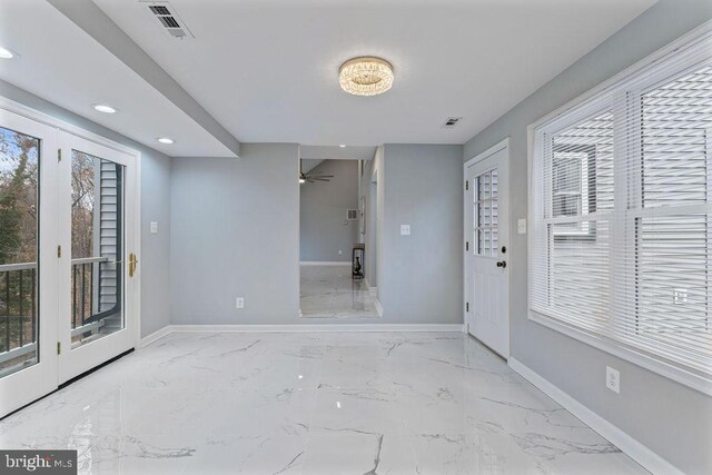 entryway with ceiling fan and a healthy amount of sunlight