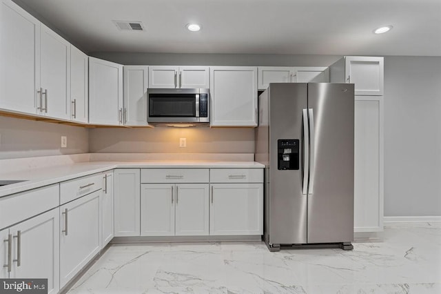 kitchen featuring white cabinetry and appliances with stainless steel finishes