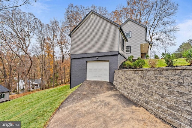 view of home's exterior with a yard and a garage