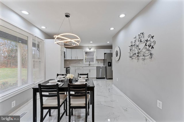 dining room with a chandelier and sink