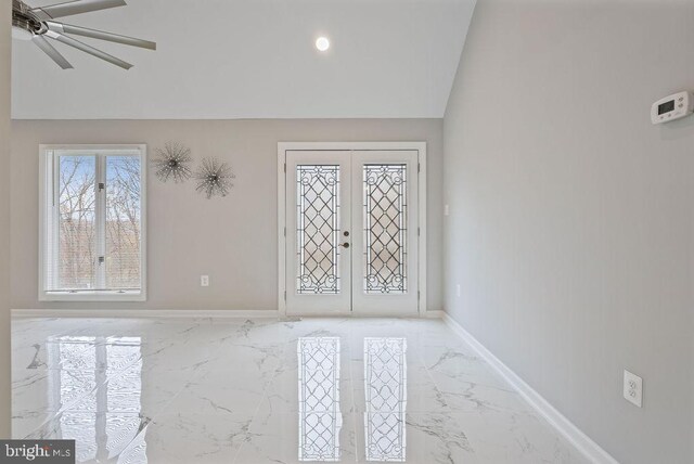 foyer entrance featuring french doors and lofted ceiling