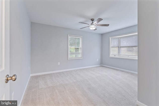 carpeted empty room featuring ceiling fan