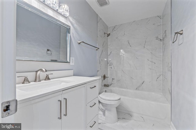 full bathroom with vanity, toilet, and tiled shower / bath