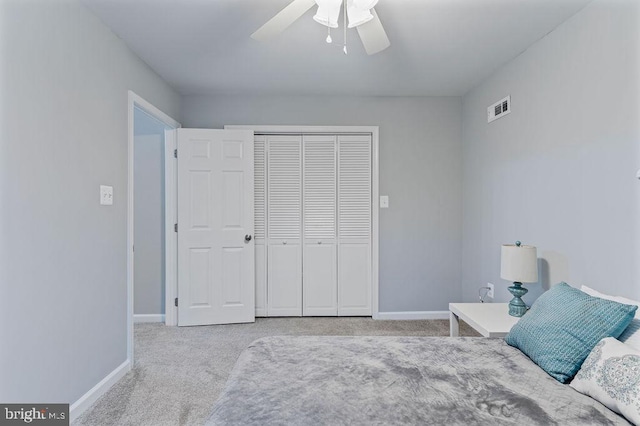 carpeted bedroom with a closet and ceiling fan