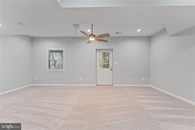 spare room featuring light carpet and ceiling fan