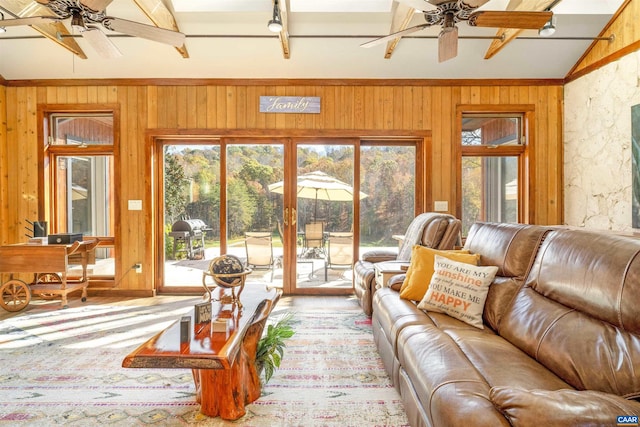 sunroom / solarium featuring vaulted ceiling with beams and ceiling fan