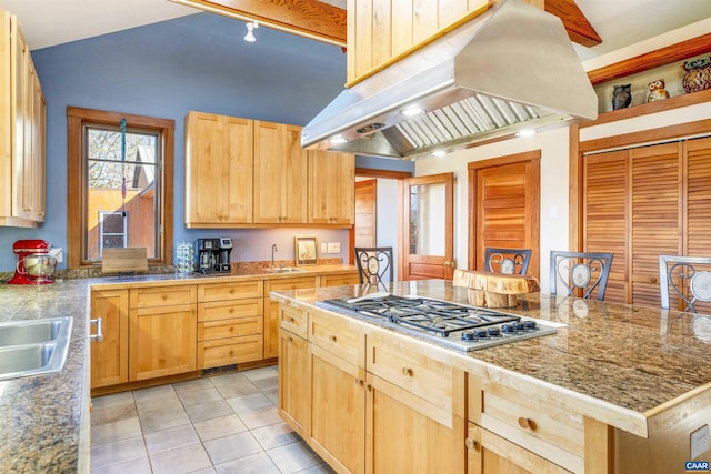 kitchen featuring sink, island exhaust hood, stainless steel gas stovetop, light brown cabinetry, and light tile patterned flooring