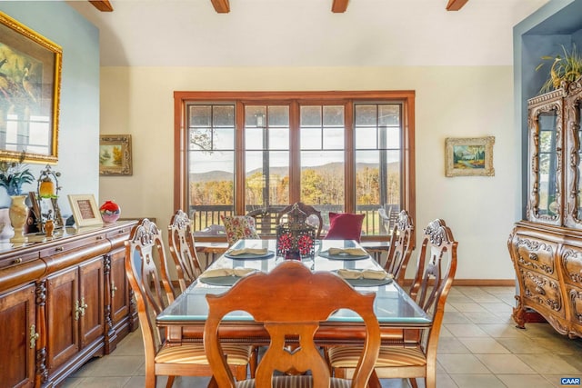 dining space featuring ceiling fan, a mountain view, and light tile patterned floors