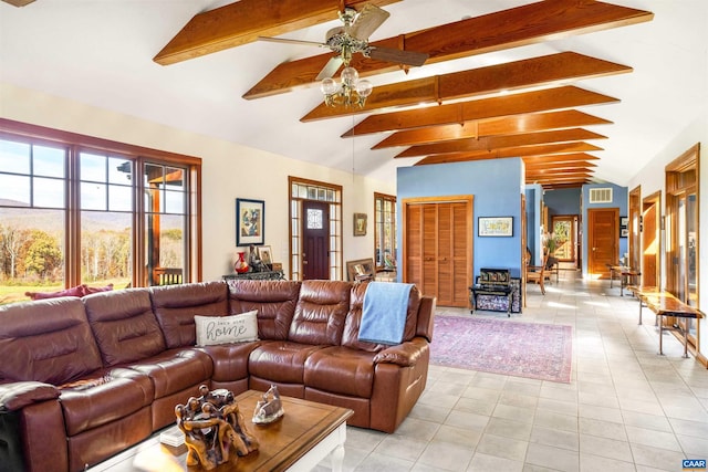 living room with vaulted ceiling with beams, ceiling fan, and light tile patterned floors