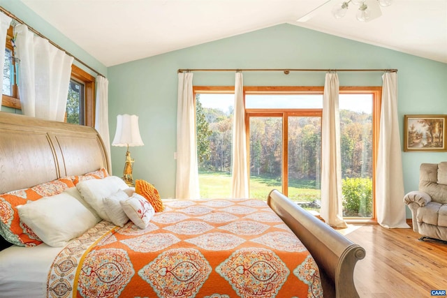 bedroom featuring hardwood / wood-style flooring and lofted ceiling