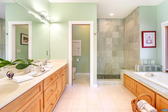 full bathroom with tile patterned floors, separate shower and tub, vanity, and toilet