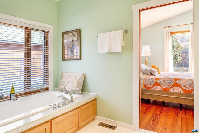 bathroom featuring lofted ceiling and wood-type flooring