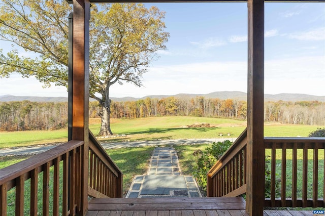 view of yard with a deck with mountain view