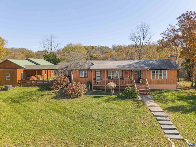 ranch-style house featuring central AC and a front lawn