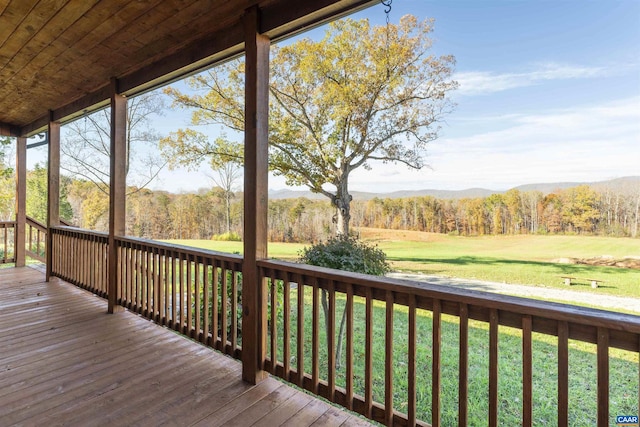 wooden terrace with a lawn