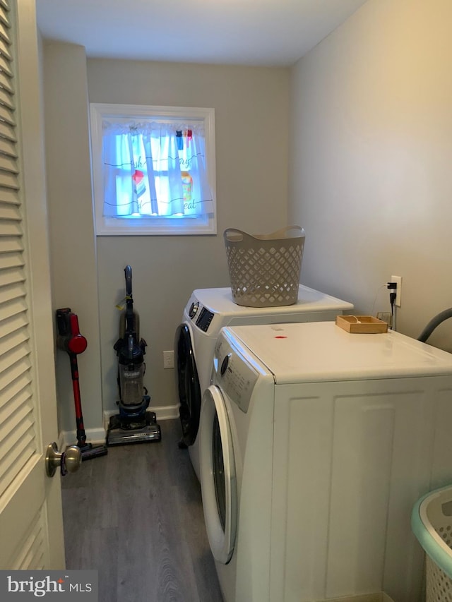 washroom with washing machine and dryer and dark wood-type flooring