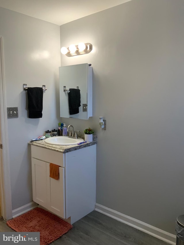 bathroom featuring vanity and hardwood / wood-style flooring