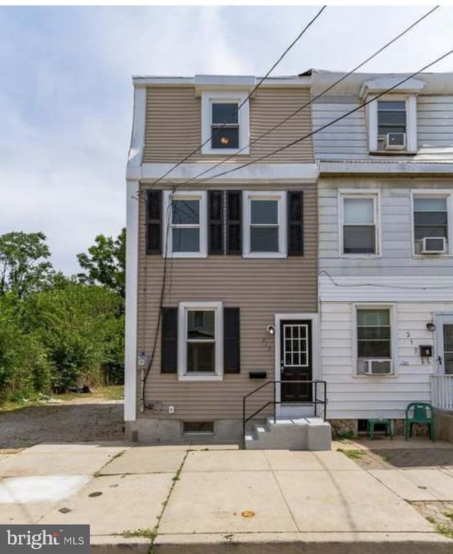 view of front of home featuring cooling unit and a patio area