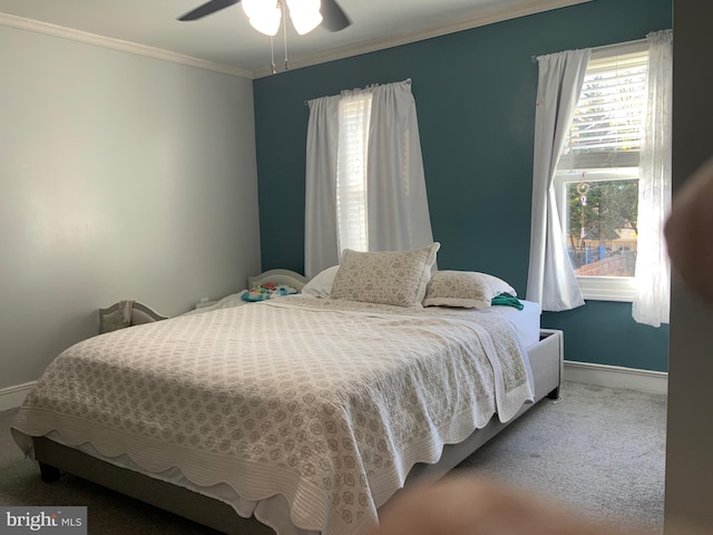 carpeted bedroom with ceiling fan and crown molding