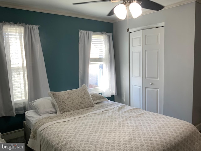 bedroom with ceiling fan, a closet, and crown molding