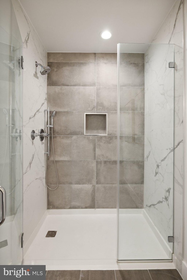 bathroom with tile patterned floors and an enclosed shower