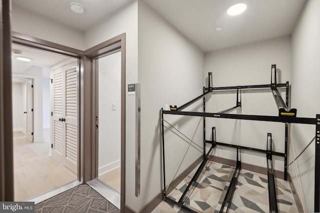 hallway with light hardwood / wood-style flooring