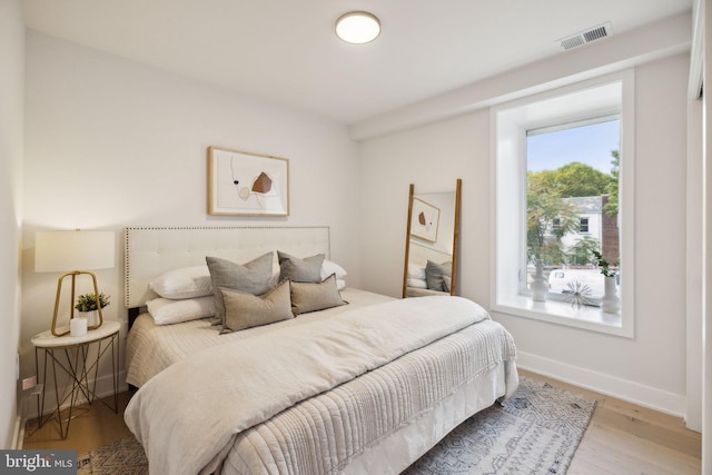 bedroom with hardwood / wood-style floors