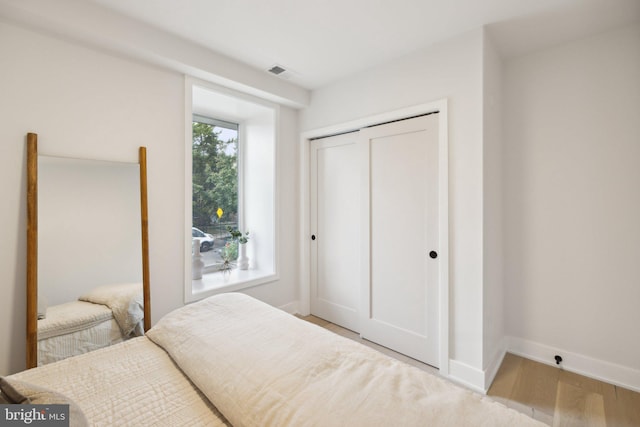 bedroom with a closet and light wood-type flooring