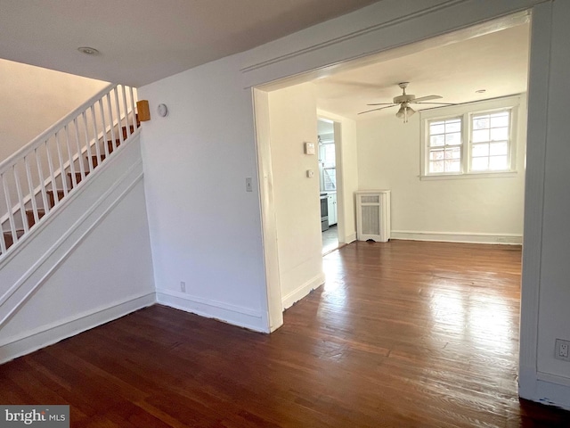 empty room featuring dark hardwood / wood-style floors and ceiling fan