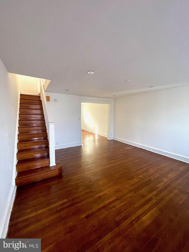 unfurnished living room featuring dark wood-type flooring