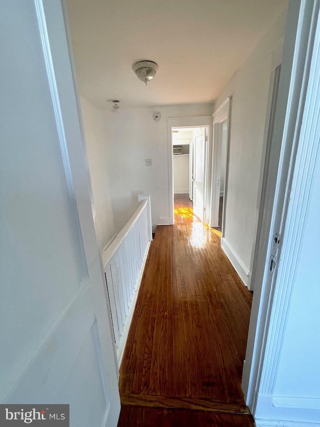 hall with a wall mounted AC and dark wood-type flooring