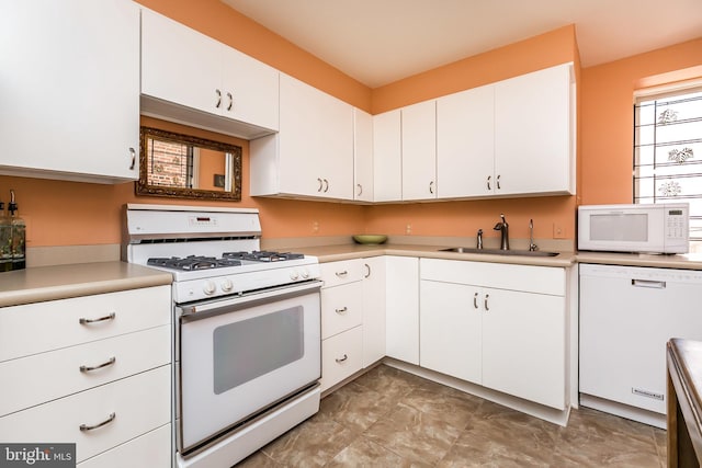 kitchen featuring white cabinets, white appliances, and sink