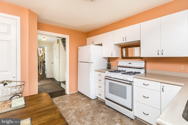 kitchen with white cabinets and white appliances