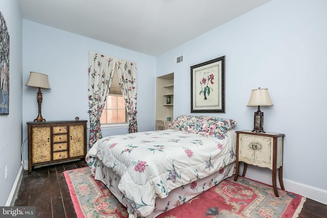 bedroom featuring dark hardwood / wood-style flooring