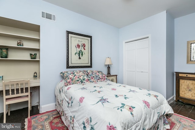 bedroom featuring dark hardwood / wood-style flooring and a closet