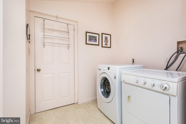 clothes washing area with washing machine and clothes dryer