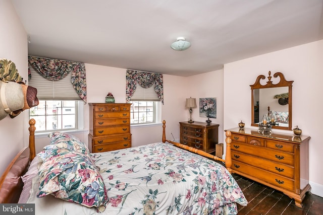 bedroom featuring dark hardwood / wood-style flooring and multiple windows