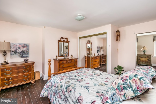 bedroom with dark wood-type flooring and a closet