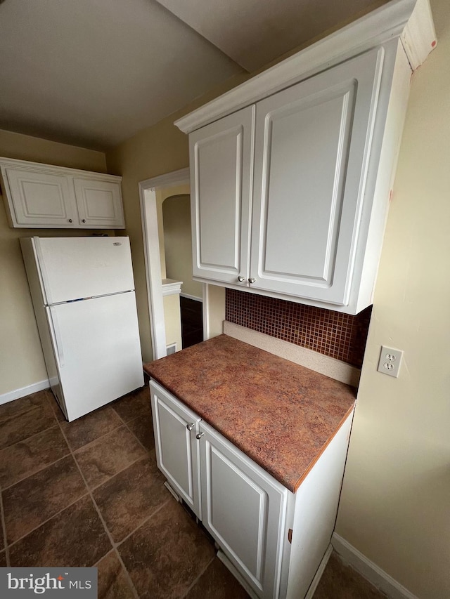 kitchen with white cabinets and white fridge