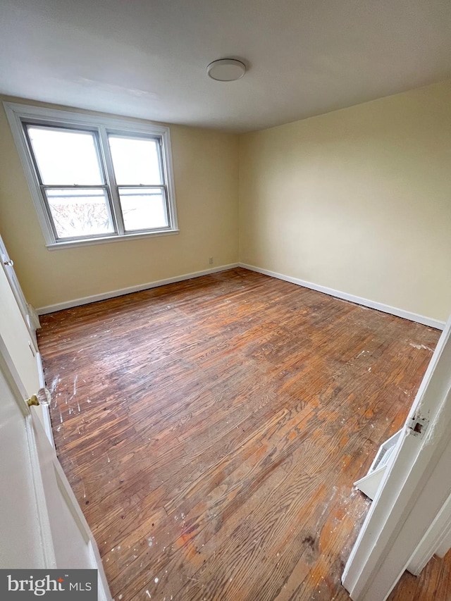 spare room with wood-type flooring