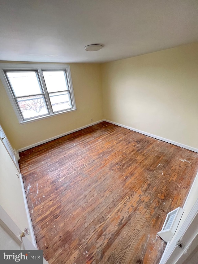 empty room with hardwood / wood-style flooring