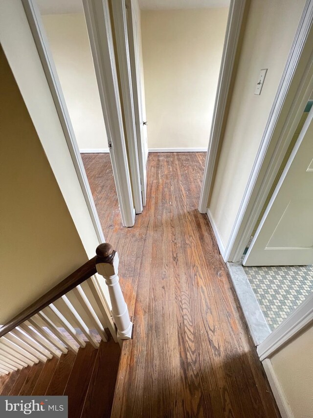 hall with hardwood / wood-style flooring