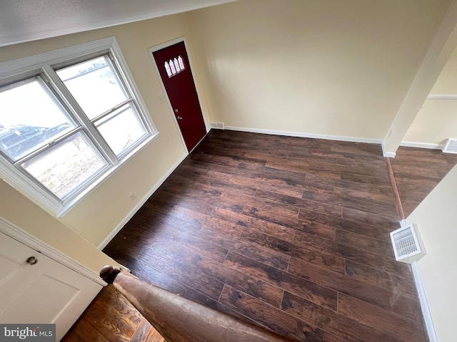 entryway featuring dark wood-type flooring and vaulted ceiling