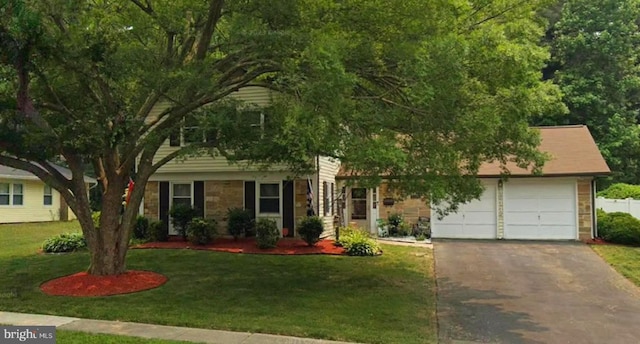 view of front of house with a front yard and a garage