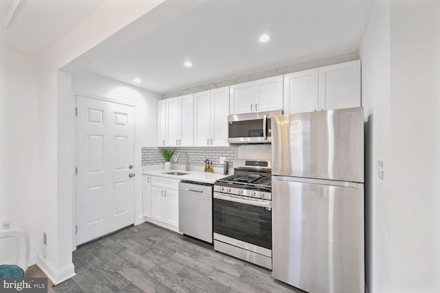 kitchen with white cabinetry, sink, and stainless steel appliances