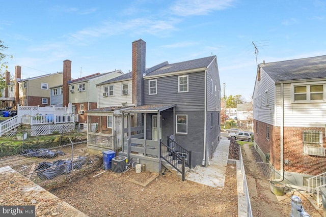 rear view of house with central AC