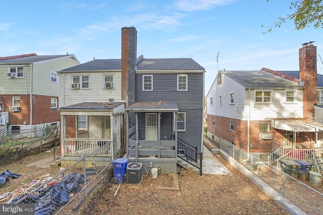 rear view of house with central AC unit